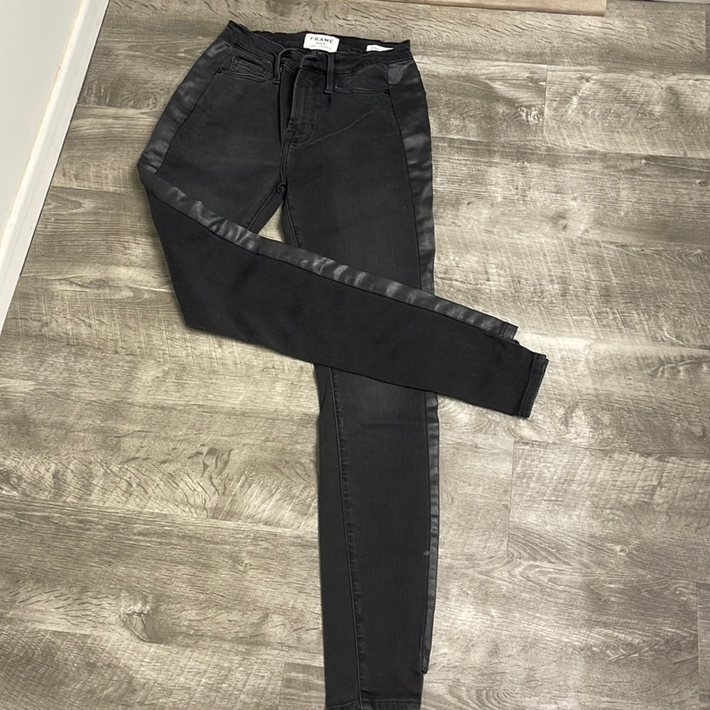 Frame denim jeans black with side seam insert cut treatment at hem line